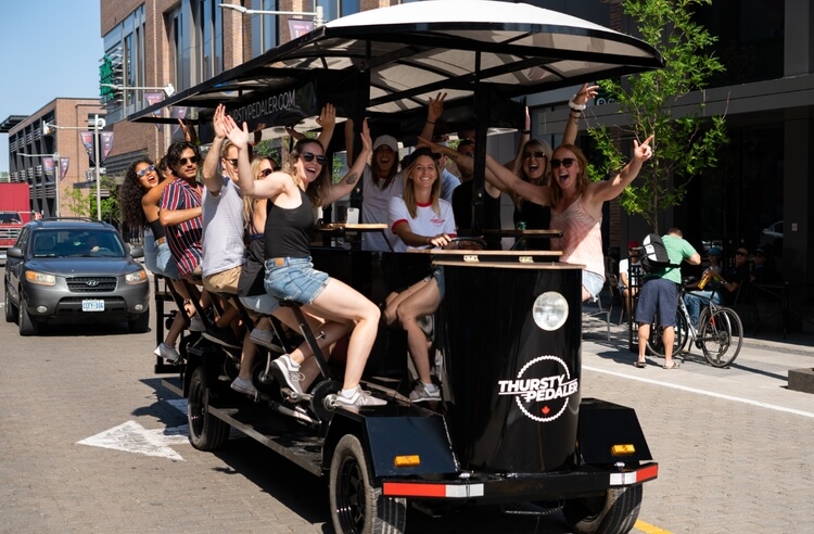 Girls waving at a camera while pedaling the tavern at Ottawa